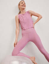 pink relaxed fit cropped tank with a scooped, ribbed neckline, and ribbed arm holes.